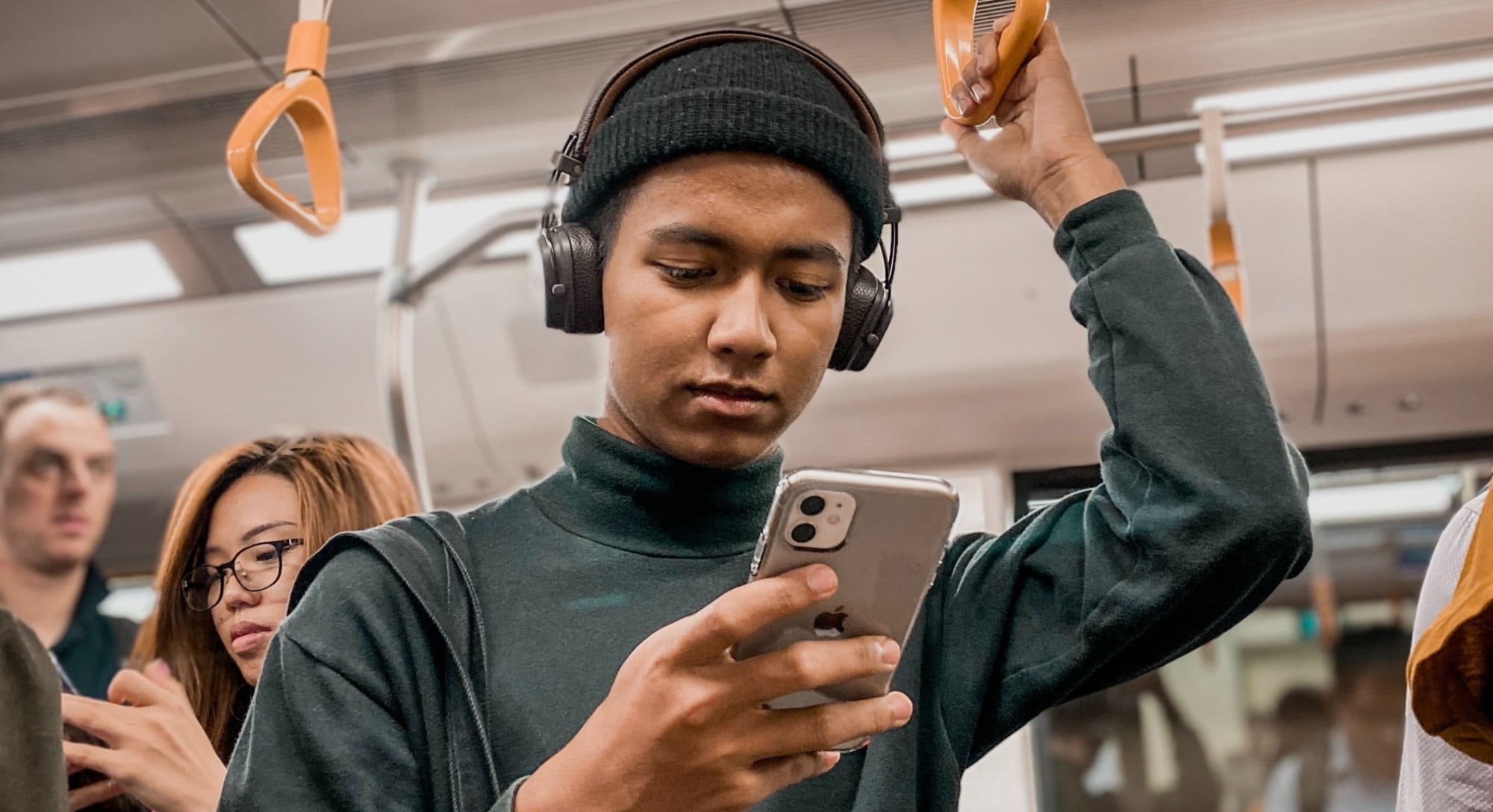 A man on a train looking his phone